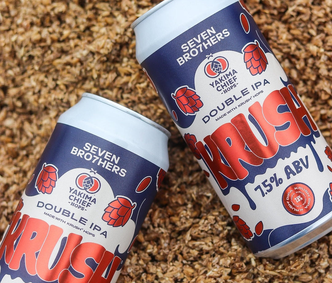 Two cans of Seven Brothers Krush Double IPA on a bed of malt.