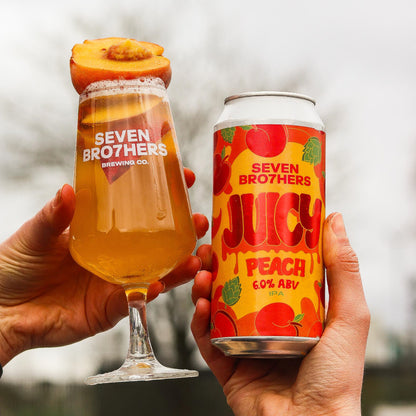 Two hands holding a glass of beer and a can of Seven Brothers Juicy Peach beer.