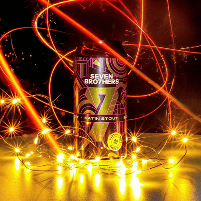 Seven Brothers Satin Stout can surrounded by colourful lights on a dark background.